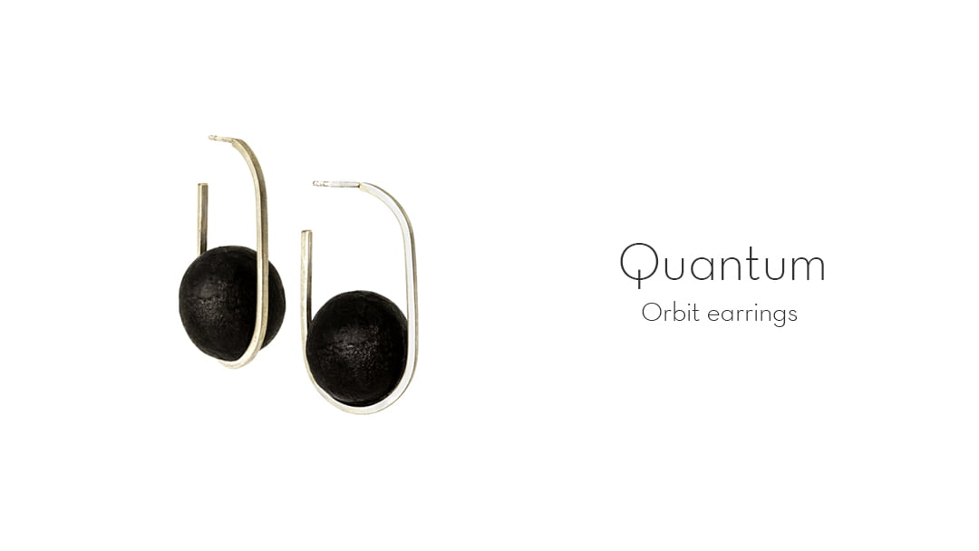 The Orbital earrings from the Quantum collection, handcrafted by Julie Bégin using sterling silver and hand charred wood.
